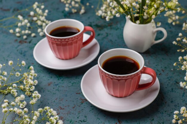 Victoria sponge cake slices with a cup of coffee on light