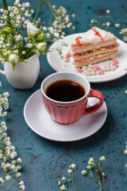 Victoria sponge cake slices with a cup of coffee on light