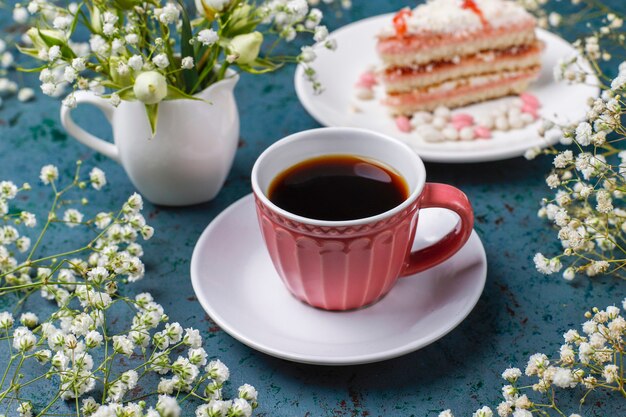 Victoria sponge cake slices with a cup of coffee on light