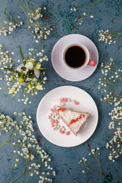 Victoria sponge cake slices with a cup of coffee on light