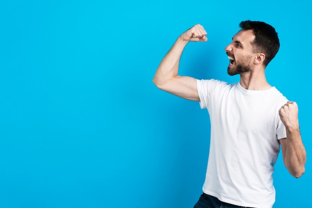 Victorious man posing with bicep