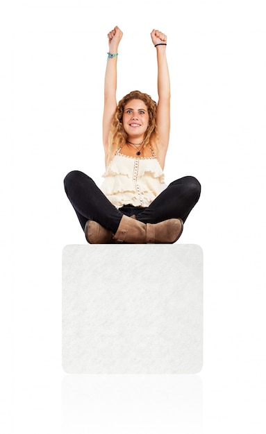 Free photo victorious woman sitting on a blank sign