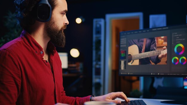 Videographer using headphones to test and improve audio quality using editing tools