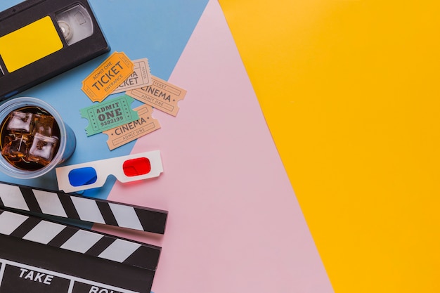 videotape with clapperboard and cinema tickets