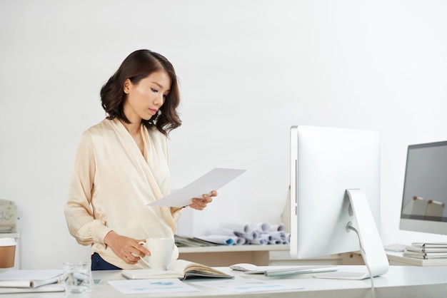 Free photo vietnamese businesswoman checking document