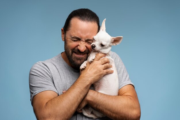 View of adorable chihuahua dog spending time with male owner at home