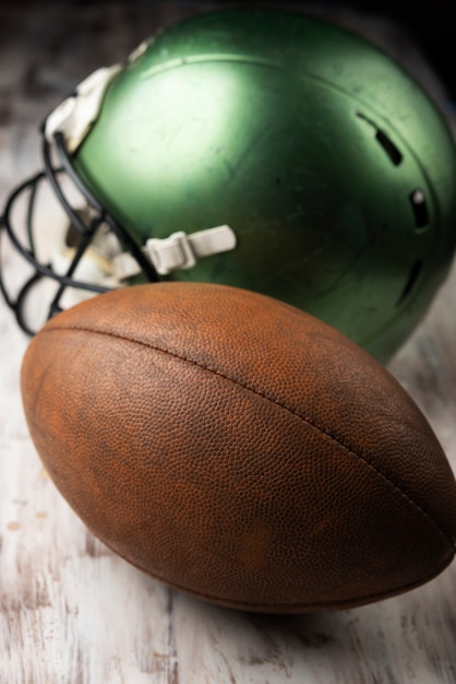 View of american football ball with helmet