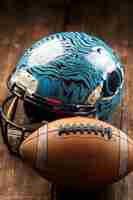 Free photo view of american football ball with helmet