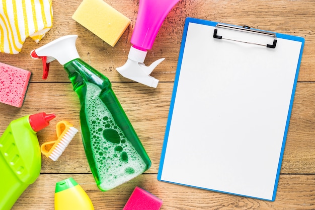 Above view arrangement with cleaning products and clipboard