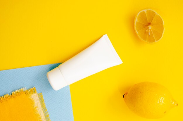 Above view arrangement with cream bottle and lemons