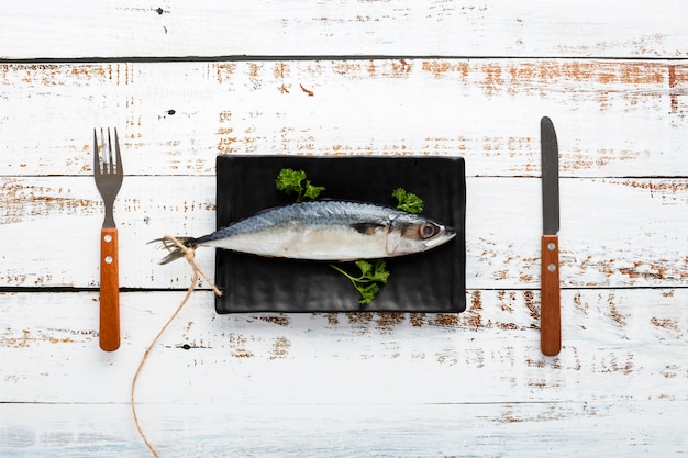 Free photo above view arrangement with fish and tableware