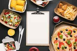 Free photo above view arrangement with food and clipboard