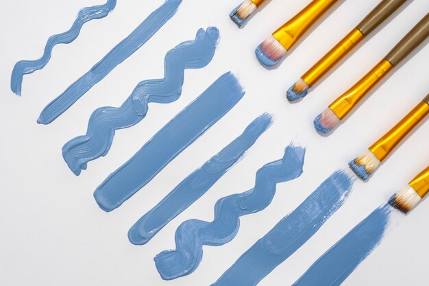 View of assortment of brushes with blue paint