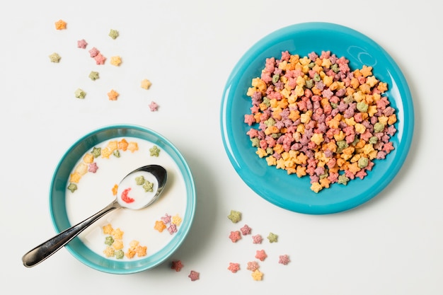 Above view assortment with bowl with milk and cereals