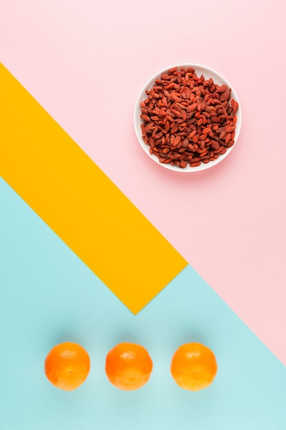 Free photo above view assortment with dried berries and oranges