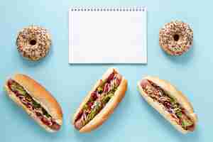 Free photo above view assortment with hot dogs and blue background