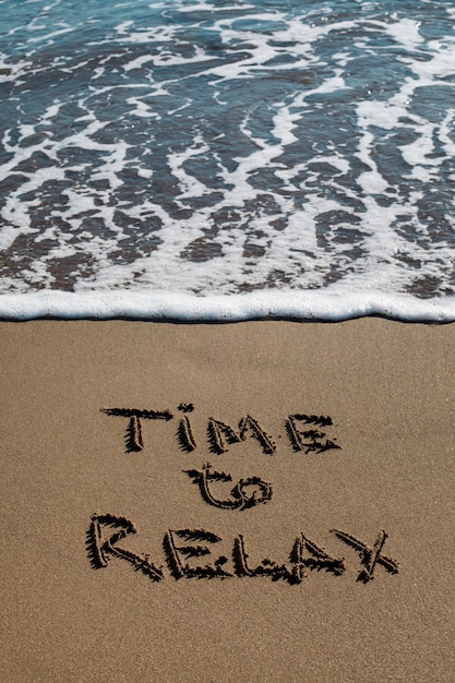 Free photo view of beach sand in summertime with message written in it