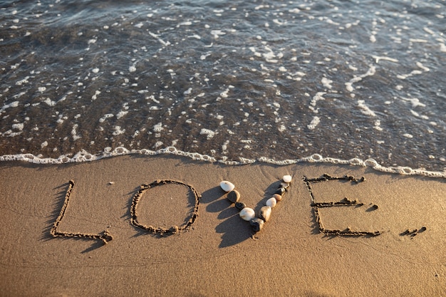 Free photo view of beach sand in summertime with message written in it