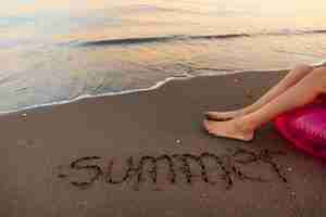 Free photo view of beach sand in summertime with message written in it