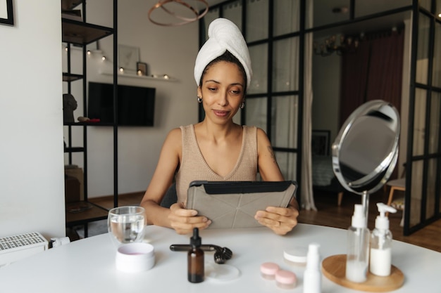 View of beautiful black woman watching at laptop