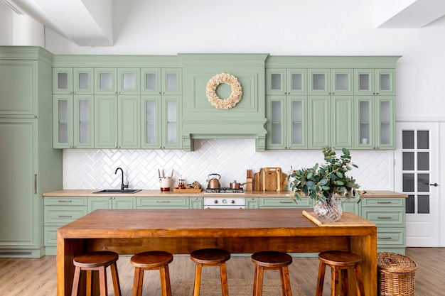 Sage green kitchen cabinets in a green color palette apartment