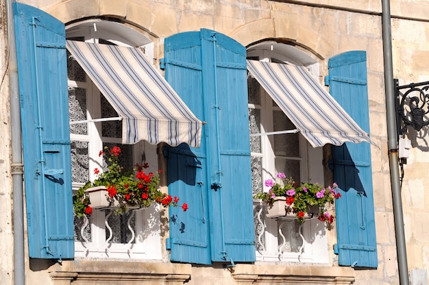 View of blue wooden windows with pots