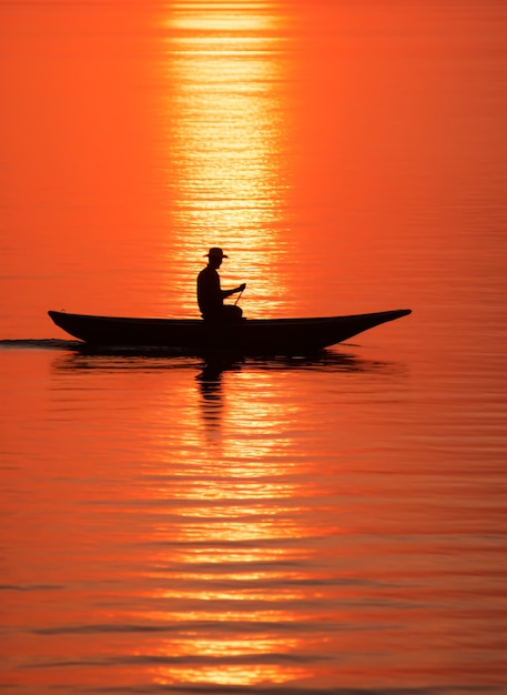 Free photo view of boat on water at sunset