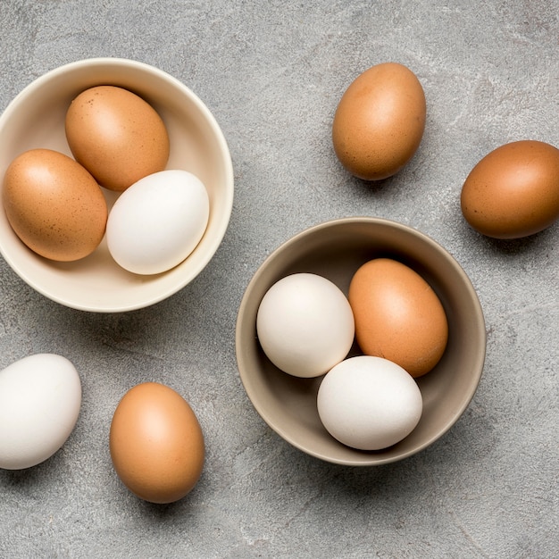 Above view bowls with chicken eggs