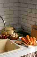 Free photo view of carrots in kitchen with other vegetables