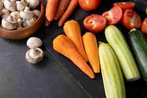 Free photo view of carrots in kitchen with other vegetables