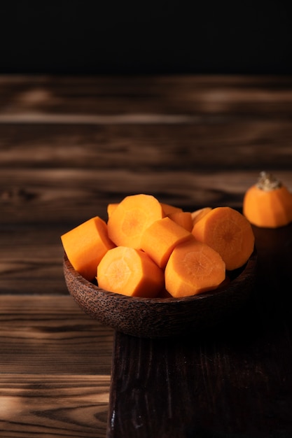 Free photo view of chopped carrots on wooden table