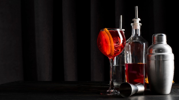 View of cocktail glass with equipment for making a drink