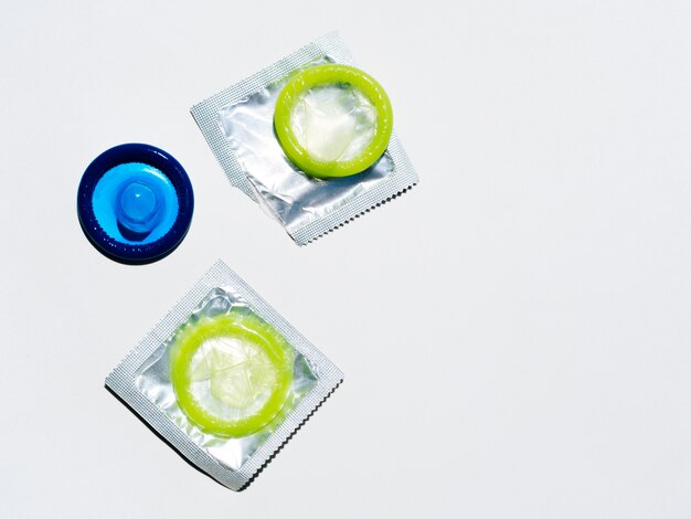 Above view colourful condoms on white background