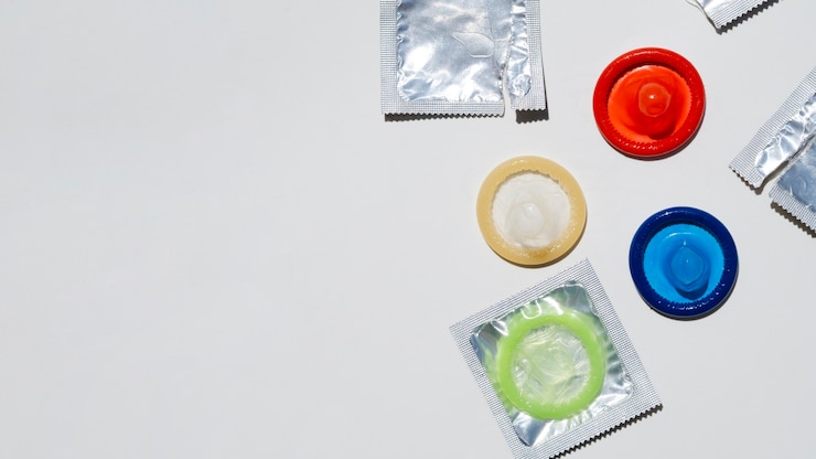 Free Photo above view colourful condoms with copy-space