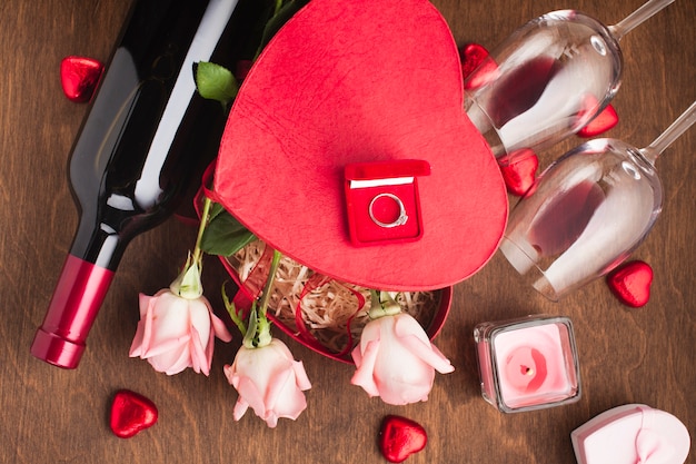 Above view composition with roses and engagement ring