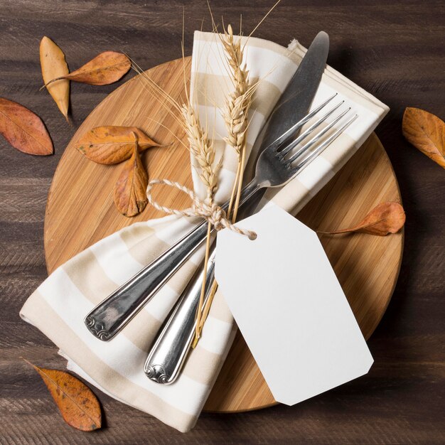 Above view cutlery with autumn leaves