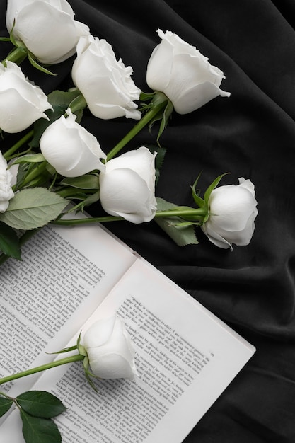 View of delicate white roses with book