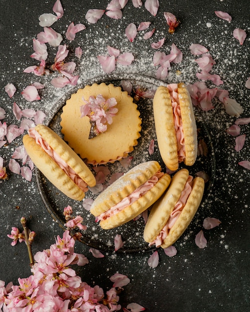 Above view delicious biscuits with flowers