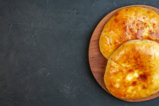 Above view of delicous fresh baked pastries on the left side on dark blackground