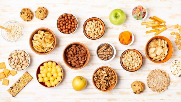 Above view different snacks in bowls