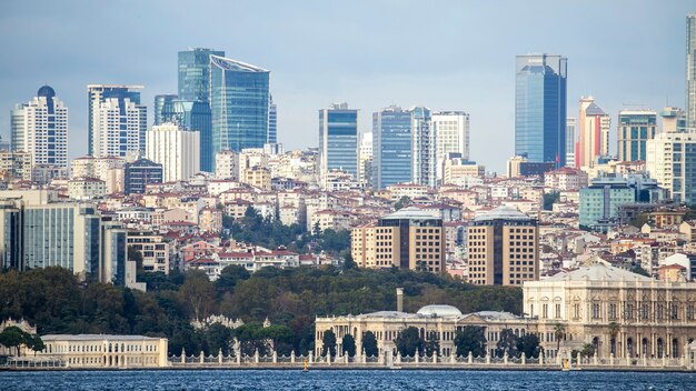 View of a district with residential and high modern buildings in Istanbul, Bosphorus Strait on the foreground, Turkey