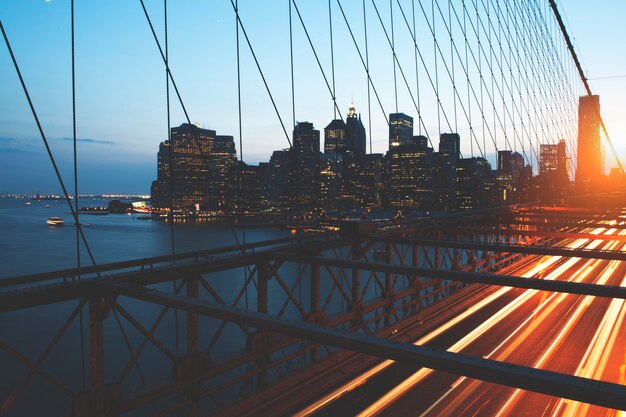 View of downtown metro city from river crossing bridge at dawn