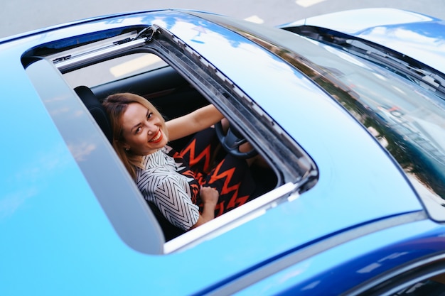 Free photo view of a driving woman through sunroof