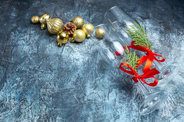 Above view of fallen glass goblets with red ribbon and decoration accessories non dark table