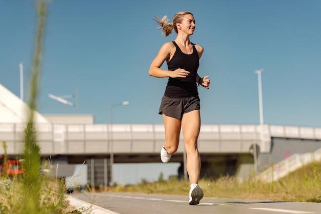 Below view of female runner jogging outdoors