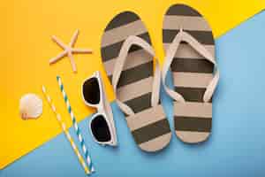 Free photo view of flip flops with summer essentials and sunglasses