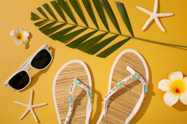 Free photo view of flip flops with summer essentials and sunglasses