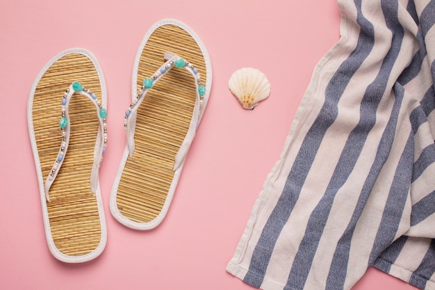 View of flip flops with summer essentials and textile