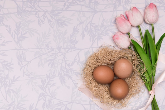 Above view frame with tulips and eggs