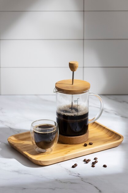 View of french press for coffee with wooden cup